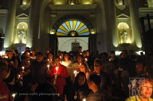 Crowds at night with candles.